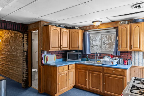 a kitchen with stainless steel appliances granite countertop a sink and cabinets