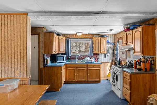 a kitchen with stainless steel appliances granite countertop a stove a sink dishwasher and a refrigerator