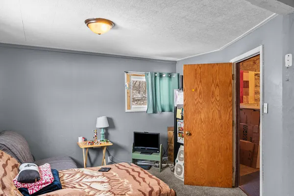a bedroom with a bed and a fireplace
