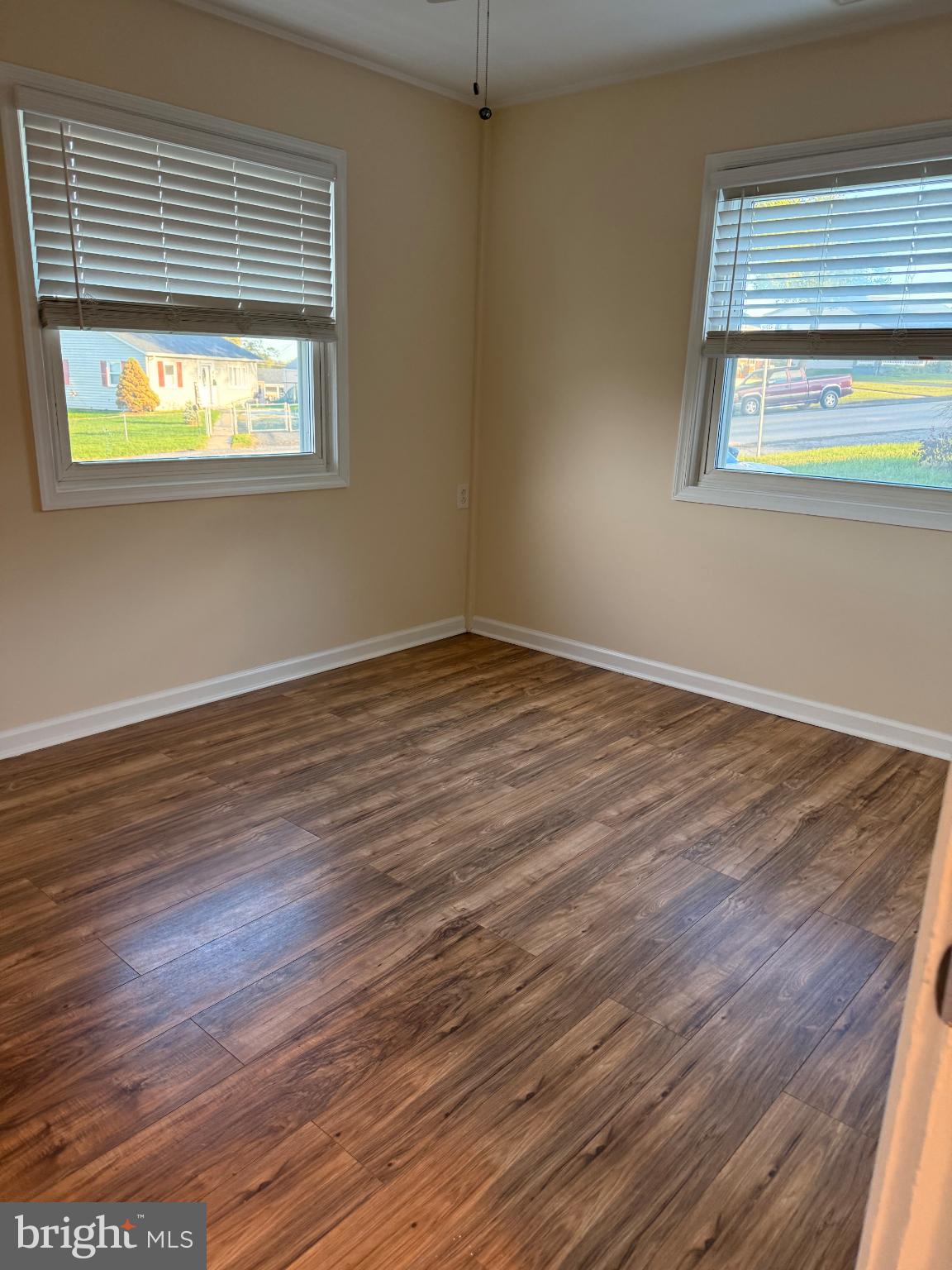 10 Compass Road Baltimore, MD 21220 - Photo 12 of 15 an empty room with wooden floor and a window