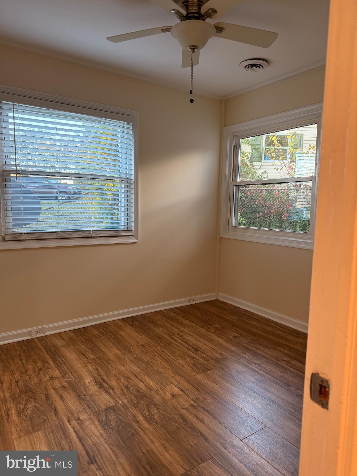 10 Compass Road Baltimore, MD 21220 - Photo 13 of 15 an empty room with wooden floor and windows