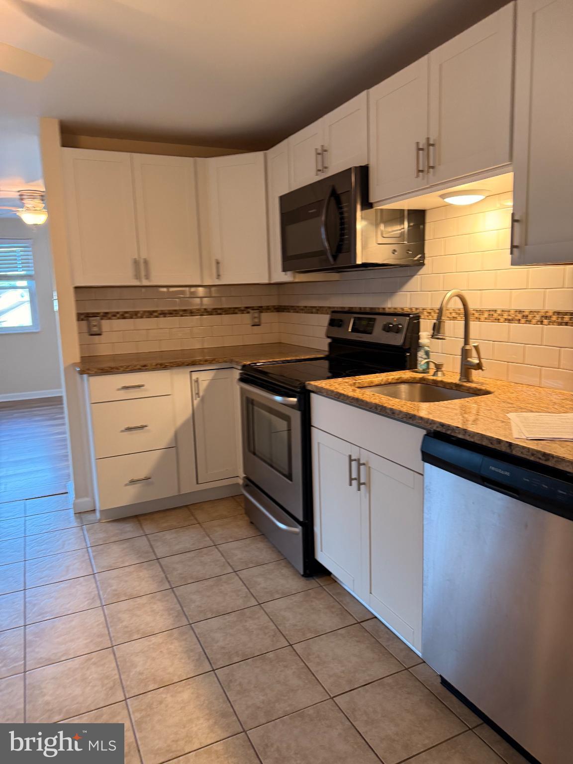 10 Compass Road Baltimore, MD 21220 - Photo 4 of 15 a kitchen with stainless steel appliances granite countertop a sink and a stove