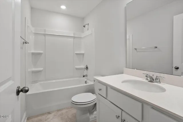 a bathroom with a sink toilet vanity and shower