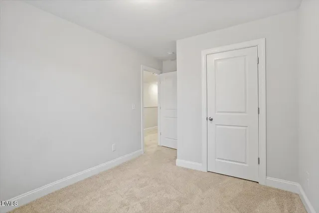 a view of an empty room and closet area