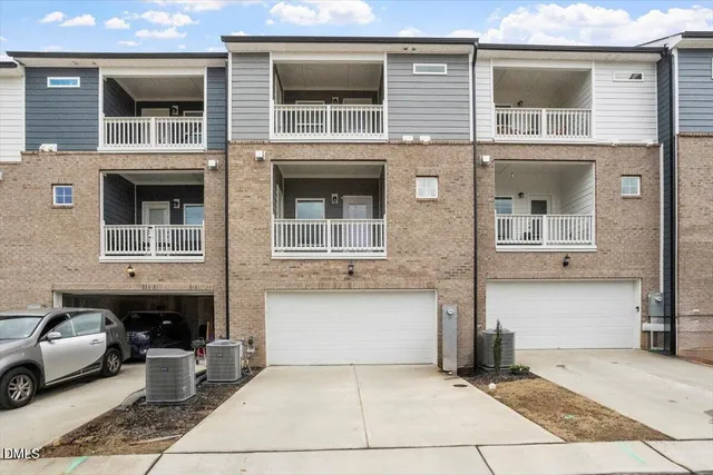 a front view of a house with parking space