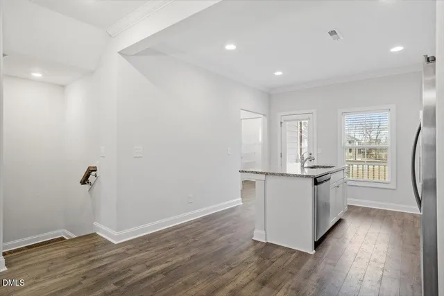 a kitchen with a refrigerator and white cabinets