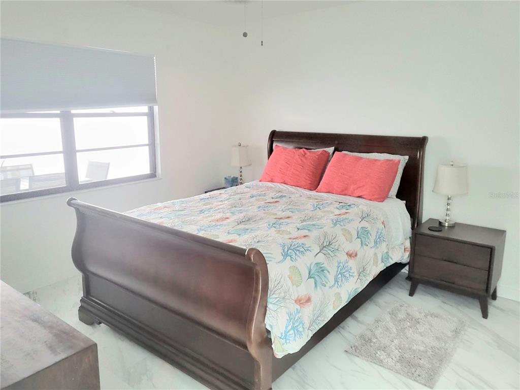 2903 63rd Street West Bradenton, FL 34209 - Photo 11 of 22 a bed sitting in a bedroom next to a window