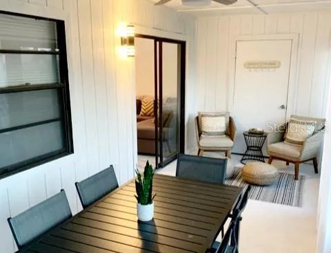 a living room with furniture wooden floor and a lamp