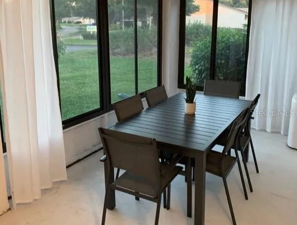 a view of a dining room with a table and chairs