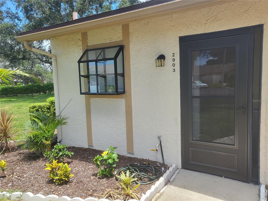 2903 63rd Street West Bradenton, FL 34209 - Photo 2 of 22 a front view of a house with a garden