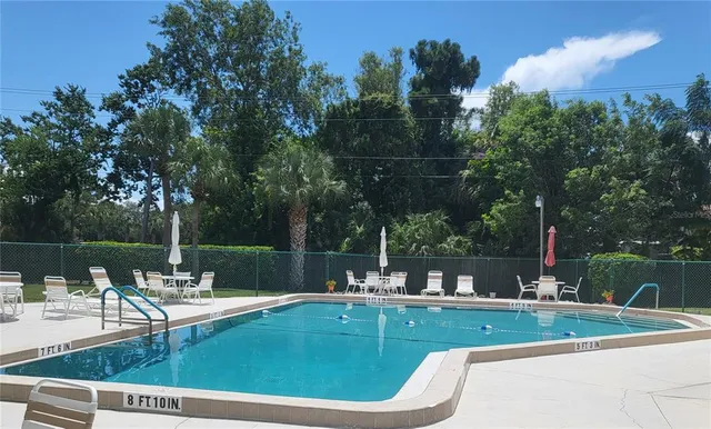 a view of a swimming pool with a table and chairs