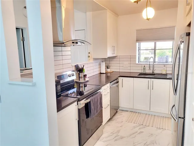 a kitchen with a sink stove and refrigerator