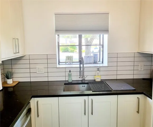 a kitchen with a sink and cabinets