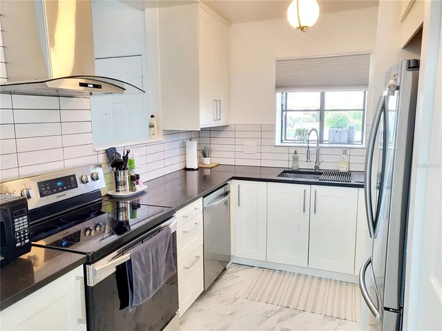 a kitchen with a sink stove and cabinets