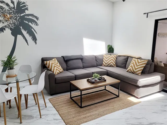 a living room with furniture and a rug