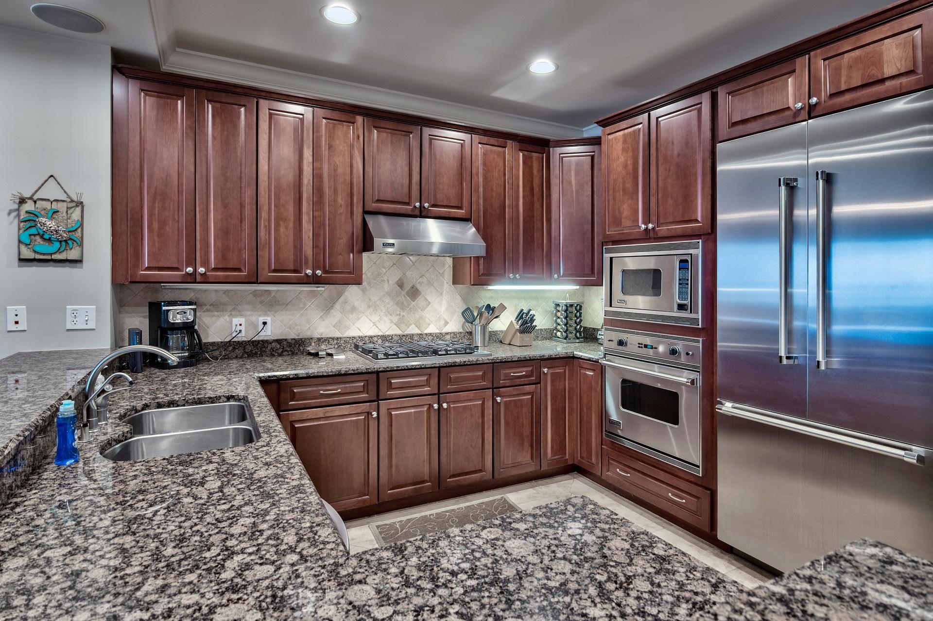 2421 West County Highway 30A, Unit C402 Santa Rosa Beach, FL 32459 - Photo 14 of 38 a kitchen with stainless steel appliances granite countertop a sink stove and refrigerator