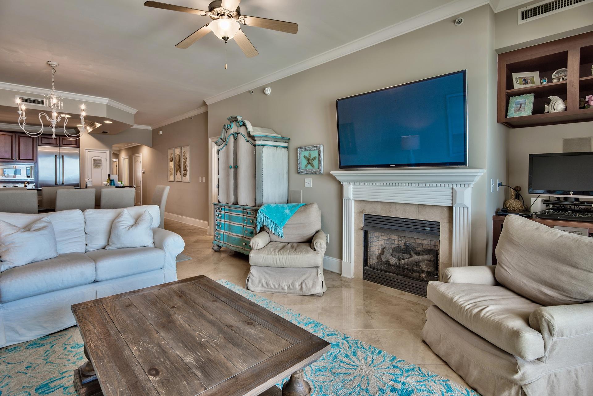 2421 West County Highway 30A, Unit C402 Santa Rosa Beach, FL 32459 - Photo 8 of 38 a living room with furniture a flat screen tv and a fireplace