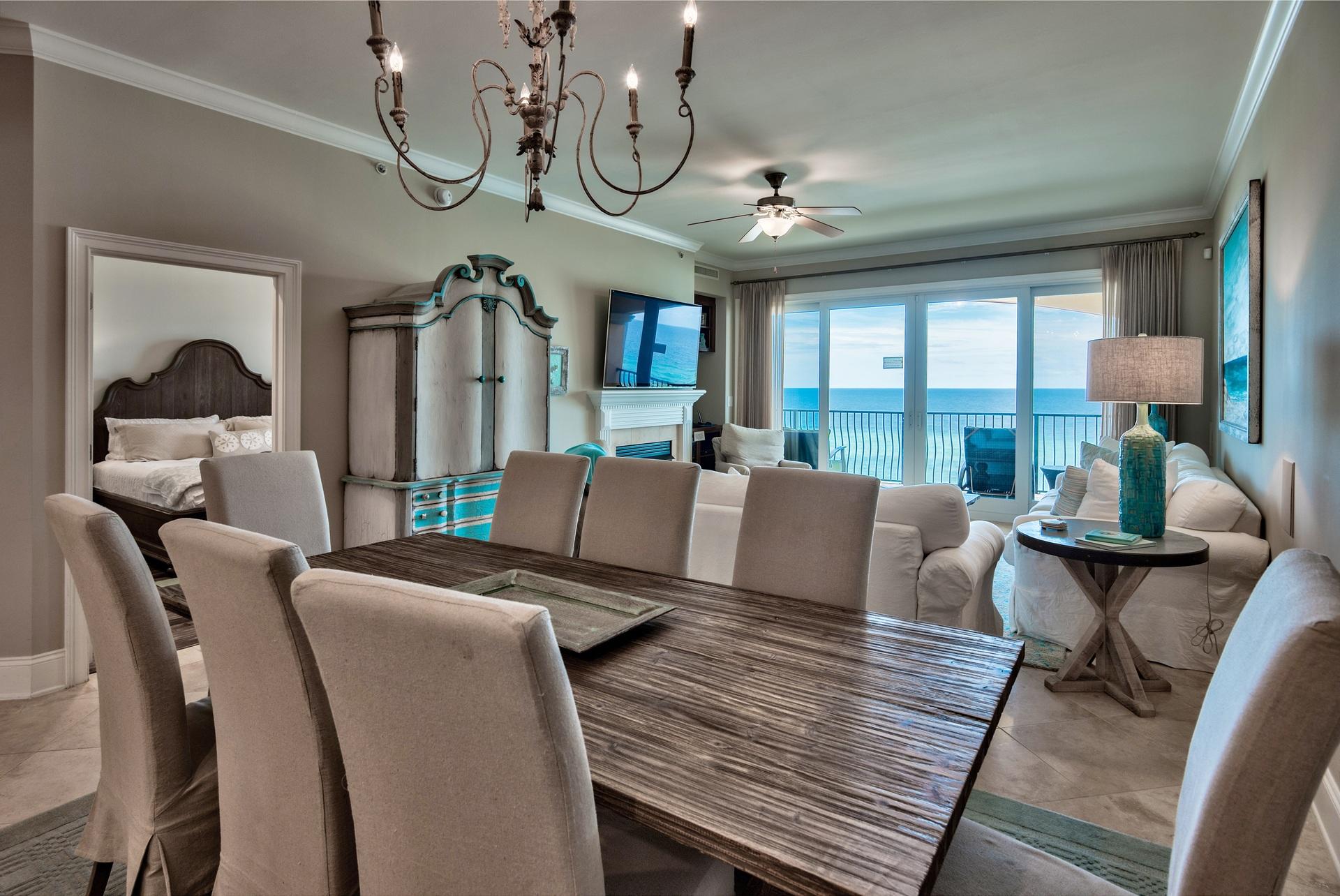 2421 West County Highway 30A, Unit C402 Santa Rosa Beach, FL 32459 - Photo 9 of 38 a living room with furniture a chandelier and a large window