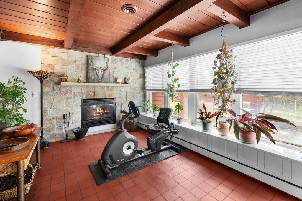 1031 27th Street Moline, IL 61265 - Photo 14 of 36 a living room with furniture gym equipment and a fireplace