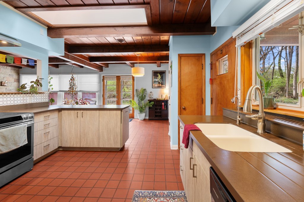 1031 27th Street Moline, IL 61265 - Photo 19 of 36 a kitchen with a sink stove and cabinets