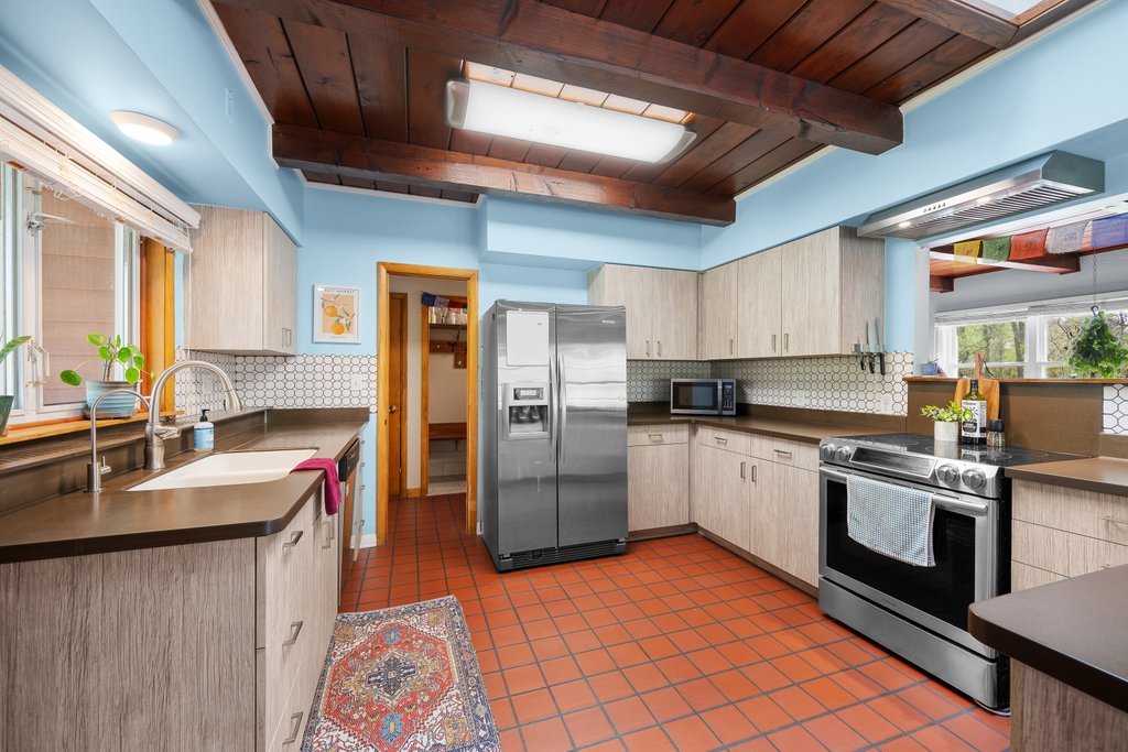 1031 27th Street Moline, IL 61265 - Photo 21 of 36 a kitchen with stainless steel appliances granite countertop a sink a stove a refrigerator cabinets and chairs