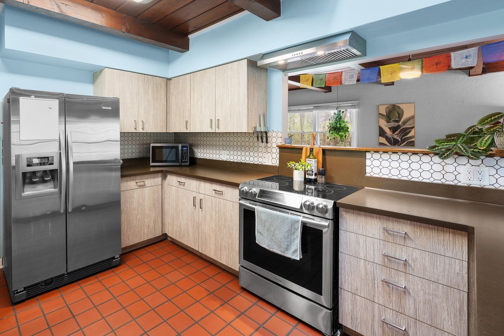 1031 27th Street Moline, IL 61265 - Photo 22 of 36 a kitchen with stainless steel appliances granite countertop a stove a sink and a refrigerator