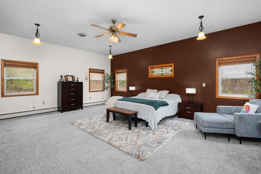 1031 27th Street Moline, IL 61265 - Photo 29 of 36 a bedroom with a bed and ceiling fan