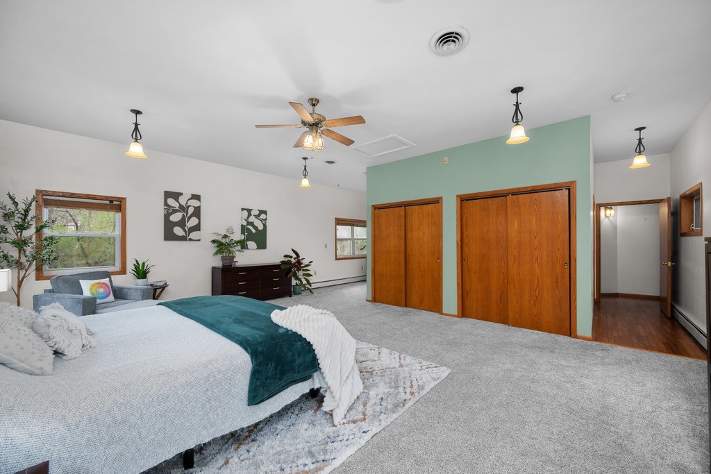 1031 27th Street Moline, IL 61265 - Photo 30 of 36 a spacious bedroom with a bed ceiling fan and a window