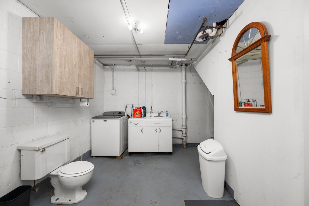 1031 27th Street Moline, IL 61265 - Photo 36 of 36 a bathroom with a sink a toilet and a mirror