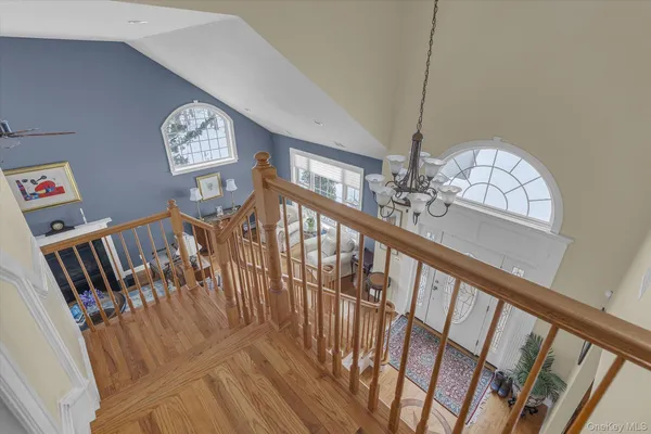 a view of staircase with railing and white walls