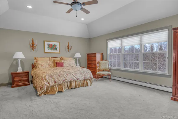 a spacious bedroom with a bed and a large window