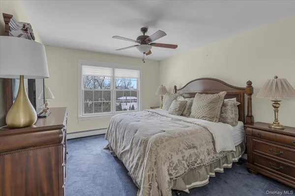 a bedroom with a bed flat screen tv and window