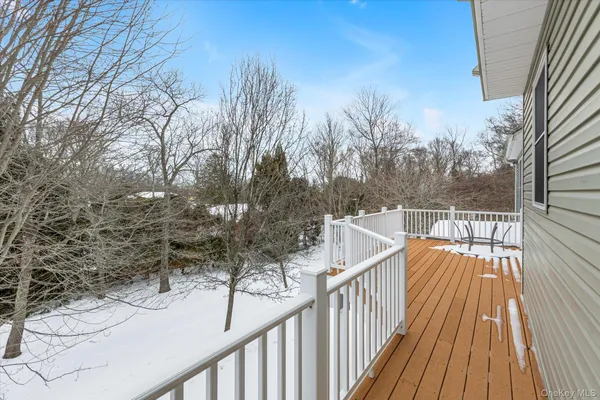 a view of a balcony with wooden floor and fence