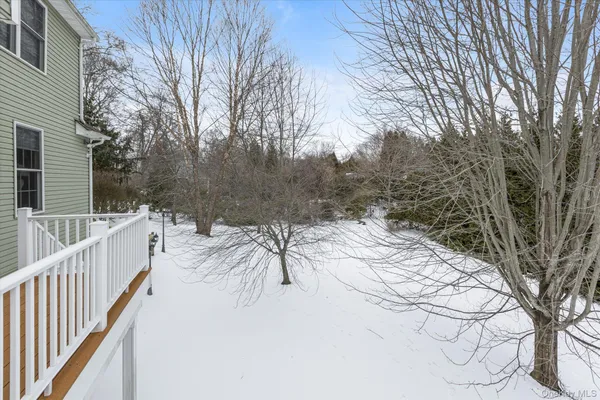 a view of a roof with wooden fence and trees