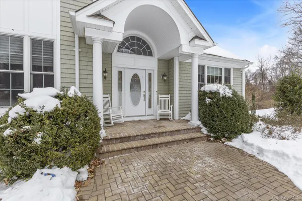 a view of a house with potted plants