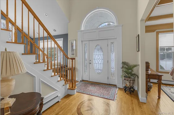 a view of staircase with lots of frames on wall and wooden floor