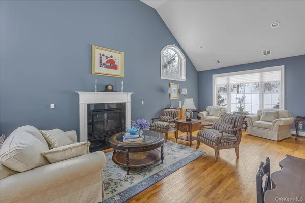 a living room with furniture a fireplace and a large window