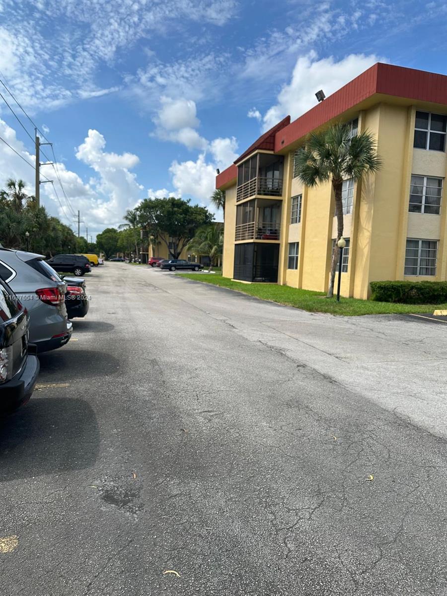 3195 Foxcroft Road, Unit F205 Miramar, FL 33025 - Photo 15 of 17 a view of a building with a street