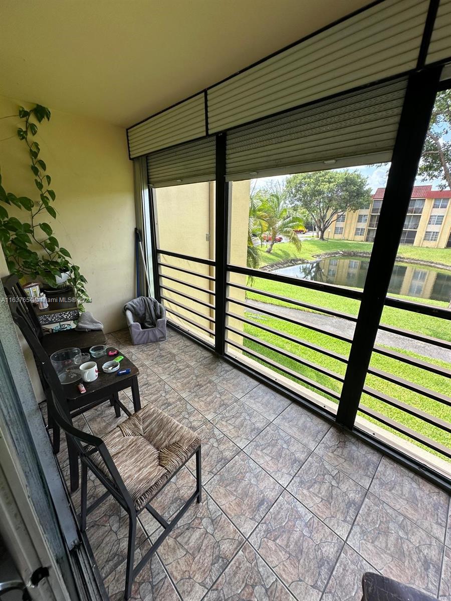 3195 Foxcroft Road, Unit F205 Miramar, FL 33025 - Photo 8 of 17 a view of a chairs and table in the patio