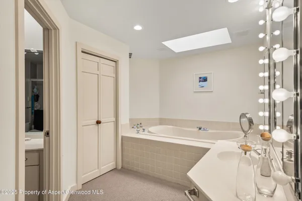 a bedroom with bed and flat screen tv