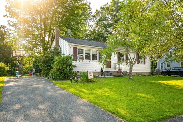 a view of a house with a yard and sitting area