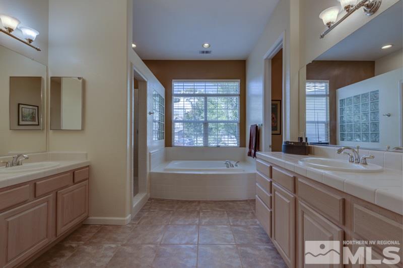 9960 Moccasin Court Reno, NV 89521 - Photo 13 of 20 a bathroom with a tub sink and mirror