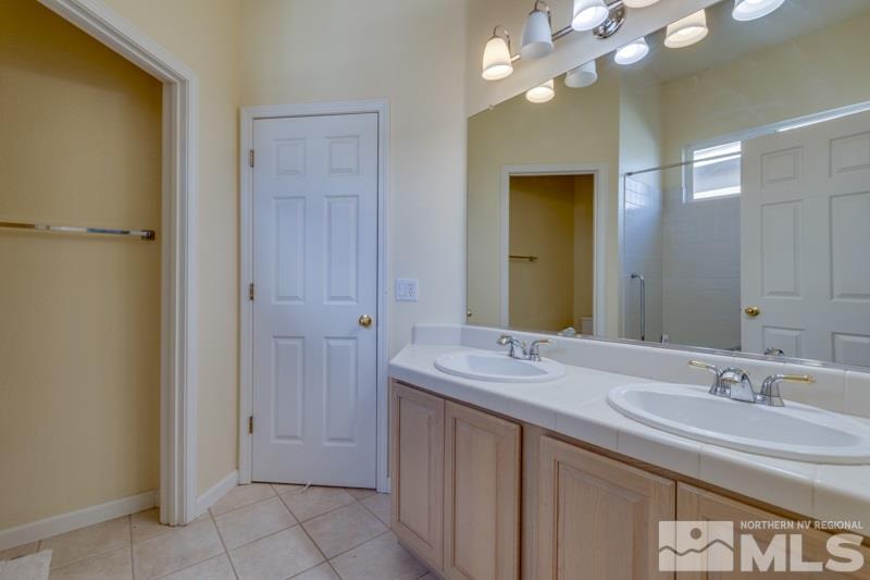 9960 Moccasin Court Reno, NV 89521 - Photo 15 of 20 a bathroom with a double vanity sink and a mirror