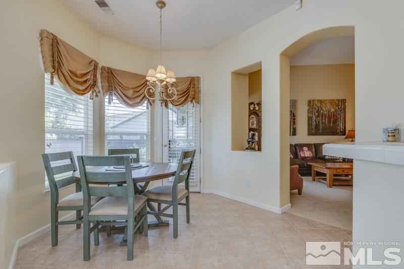 9960 Moccasin Court Reno, NV 89521 - Photo 7 of 20 a view of a dining room with furniture and chandelier