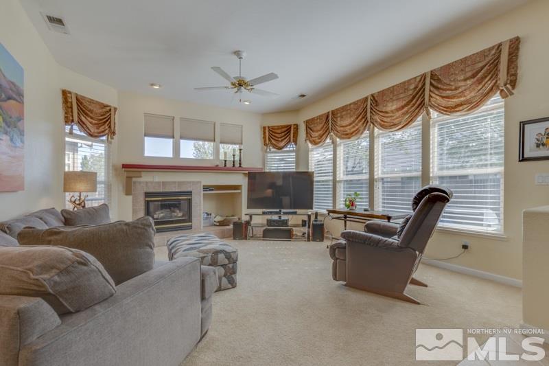9960 Moccasin Court Reno, NV 89521 - Photo 8 of 20 a living room with furniture a fireplace and a large window