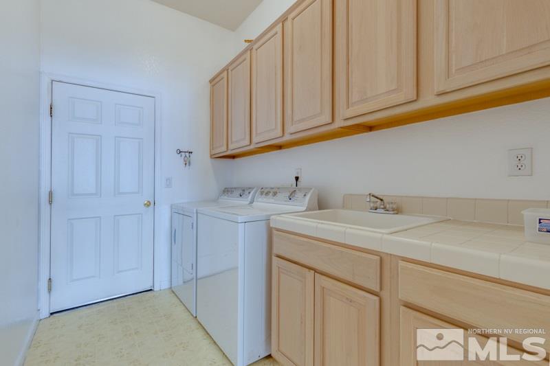 9960 Moccasin Court Reno, NV 89521 - Photo 9 of 20 a bathroom with a sink and cabinets