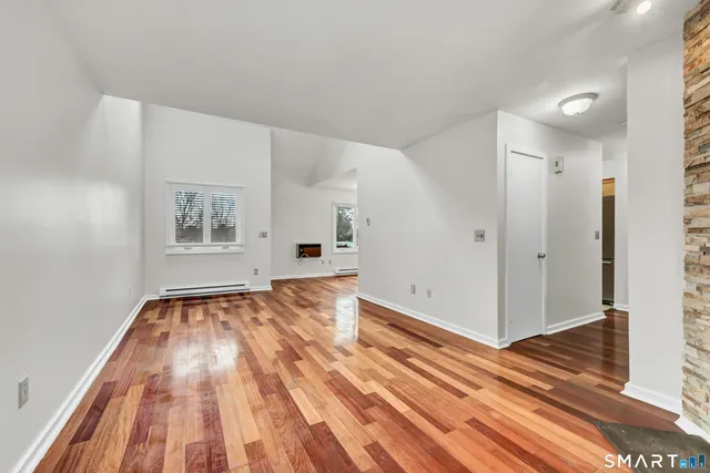a view of an empty room and wooden floor