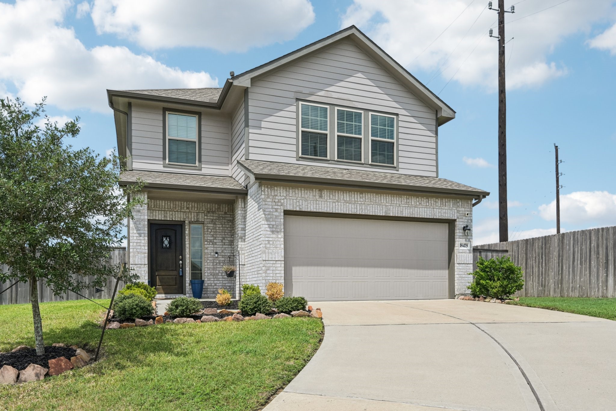 a front view of a house with a garden and plants