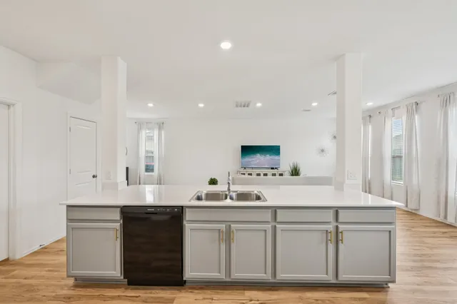 a kitchen with stainless steel appliances kitchen island granite countertop a refrigerator and microwave