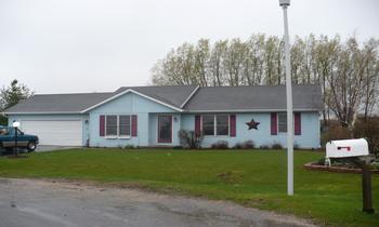 102 Gale Court Rochelle, IL 61068 - Photo 1 of 1 a front view of a house with a garden and trees